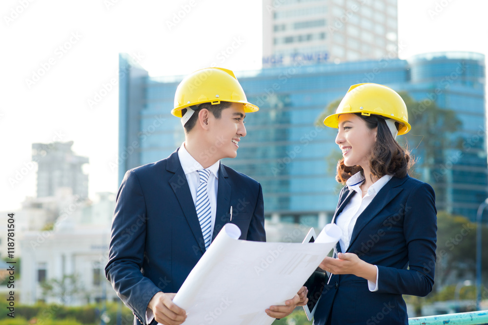 Team of engineers at the construction. Two architects discussion Team of engineers at the construction. Two architects discussion