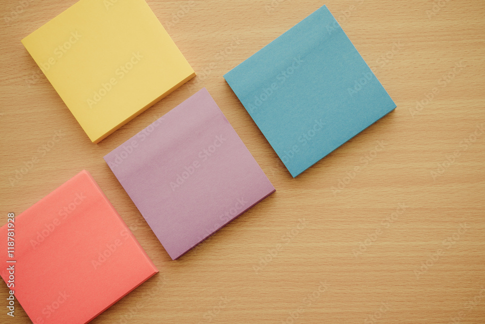 Color block of paper notes on wooden table background. Color block of paper notes on wooden table background.