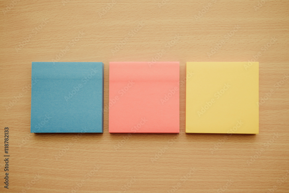 Color block of paper notes on wooden background