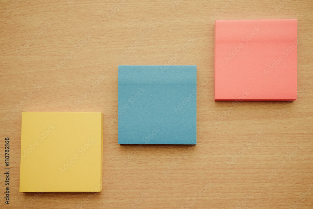 Color block of paper notes on wooden background Color block of paper notes on wooden background