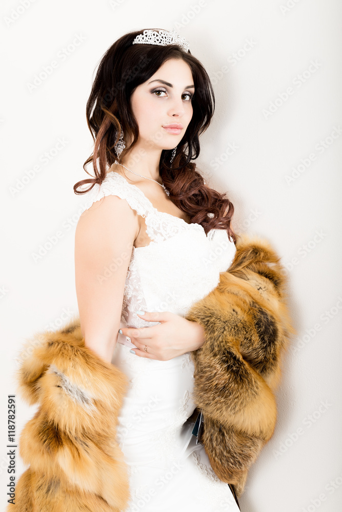 close-up portrait of young beautiful bride in a wedding dress with a wedding makeup and hairstyle. young bride in a fur coat from a red fur close-up portrait of young beautiful bride in a wedding dress with a wedding makeup and hairstyle. young bride in a fur coat from a red fur