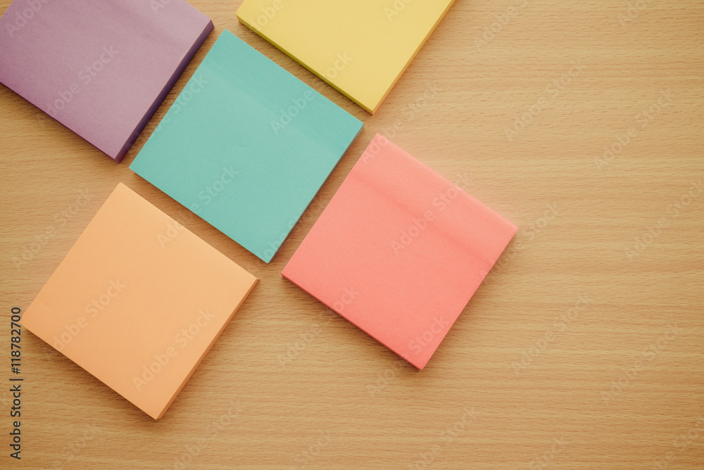 Color block of paper notes on wooden background Color block of paper notes on wooden background