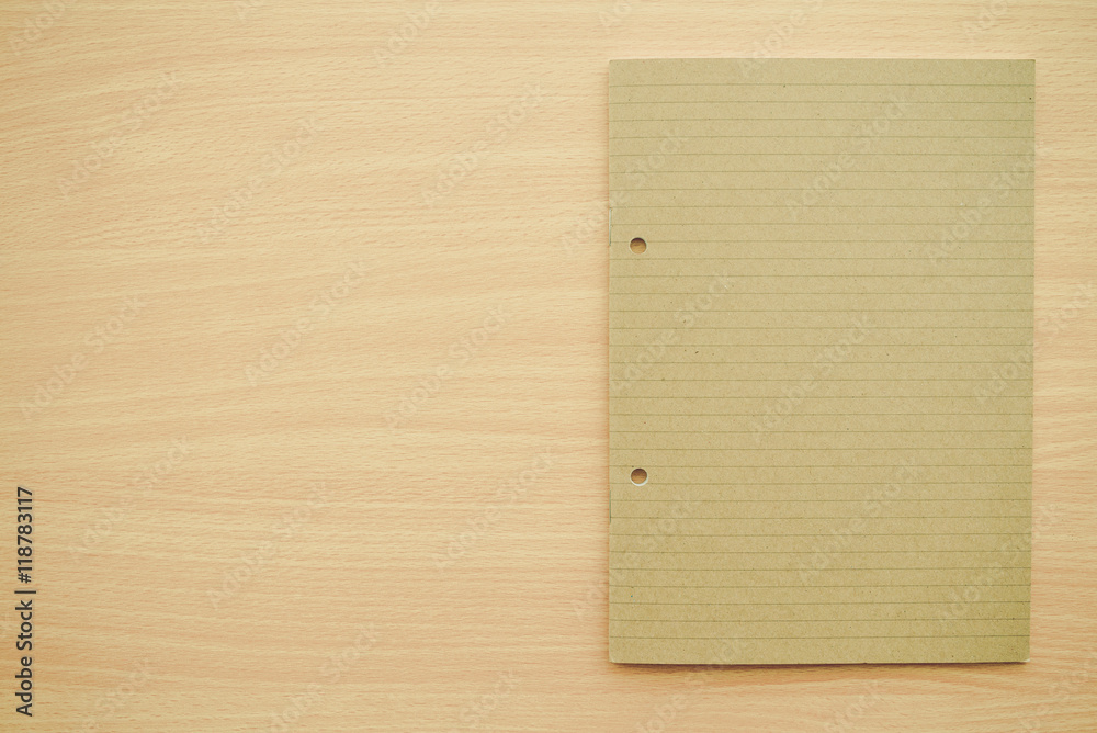 Naklejka premium Blank empty notepad on wooden table background - Business and education concept.