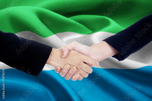 Business handshake with flag of Sierra Leone