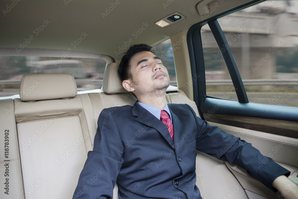 Businessman resting inside a car Businessman resting inside a car