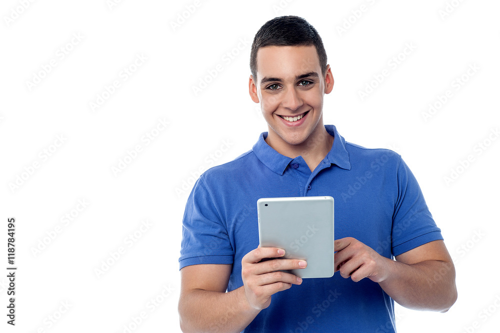Fashionable guy browsing on his tablet device Fashionable guy browsing on his tablet device