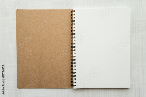Blank empty notepad on white wooden table background - Business and education concept.