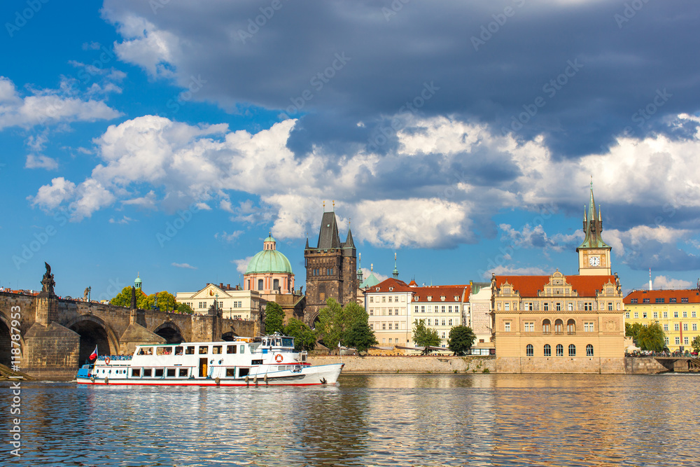 Obraz premium Prague, Czech Republic, Charles Bridge across Vltava river on which the ship sails