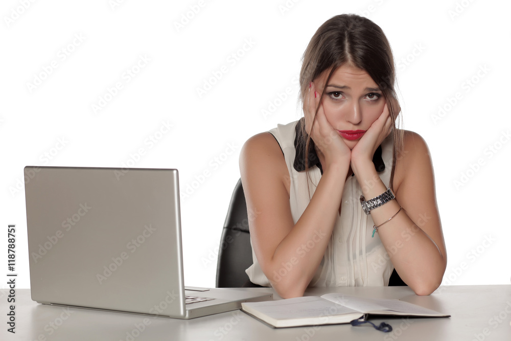 Young and worried beautiful woman with laptop and notebook Young and worried beautiful woman with laptop and notebook