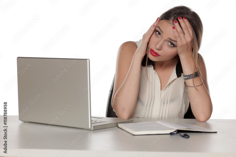 Young and worried beautiful woman with laptop and notebook Young and worried beautiful woman with laptop and notebook