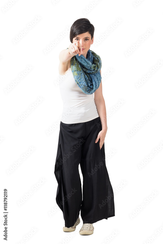 Charming young woman with scarf pointing finger at you. Full body length portrait isolated over white studio background. Charming young woman with scarf pointing finger at you. Full body length portrait isolated over white studio background.