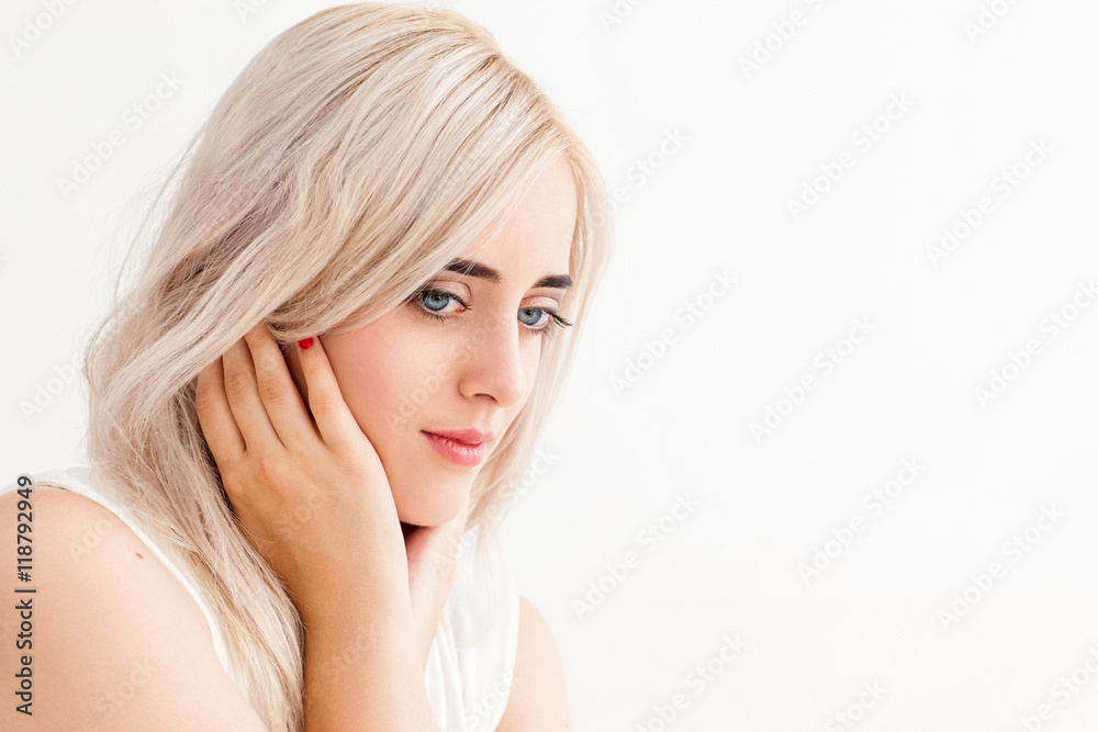 Beautiful blonde with tranquil look on her face. Young pensive woman with family issues thinking about something, copy space, white background Beautiful blonde with tranquil look on her face. Young pensive woman with family issues thinking about something, copy space, white background