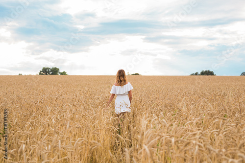 woman walking in the wheat- concept about nature, agriculture and people. © satura_