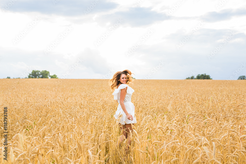 Happy woman jumping in golden wheat Happy woman jumping in golden wheat