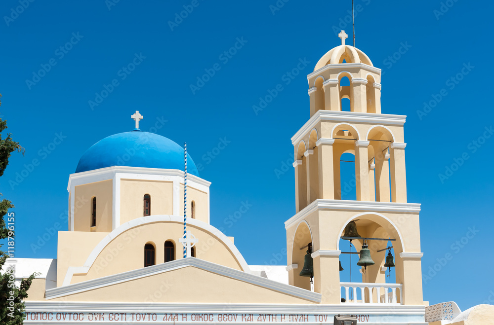 Yellow church with blue dome in Santorini
