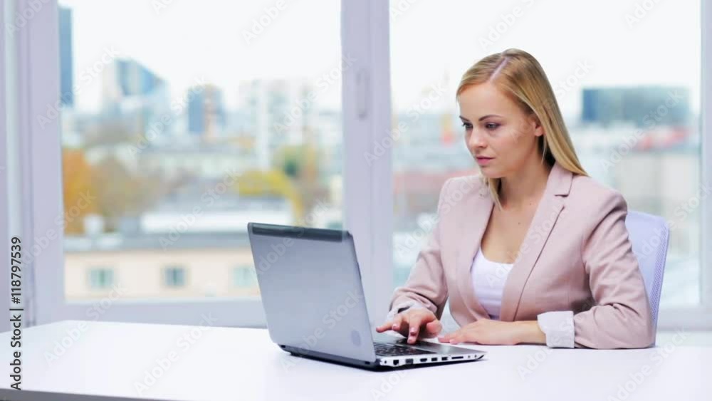young businesswoman with laptop typing at office young businesswoman with laptop typing at office