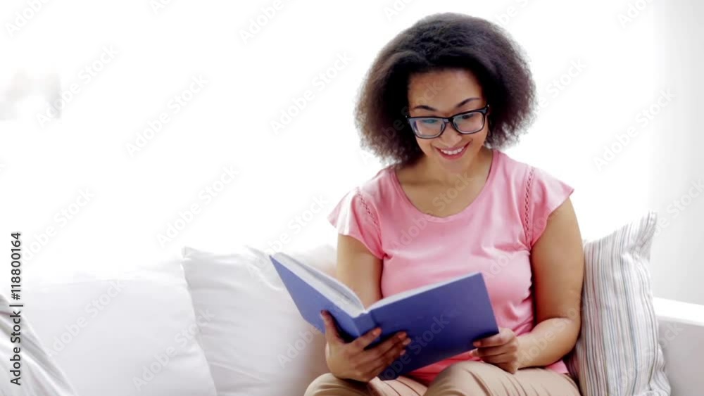 african american young woman reading book at home african american young woman reading book at home