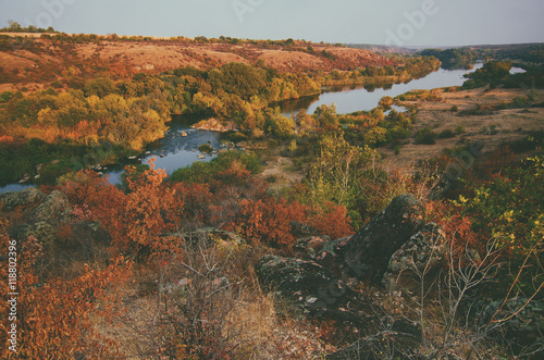 Rural autumn beautiful landscape with river and colorful trees, seasonal background