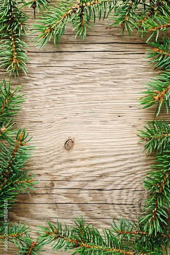 Spruce branches on wooden background