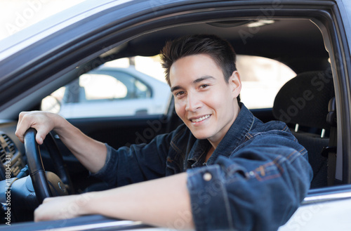 Handsome young male driver sitting in car.  © kieferpix