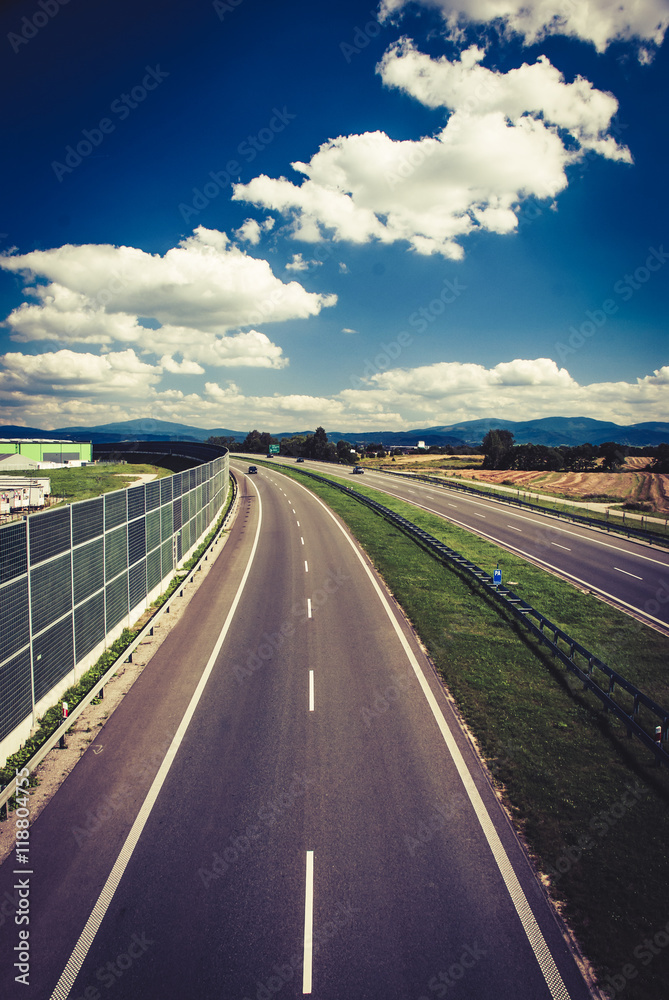 Fototapeta premium Highway against blue sky with clouds
