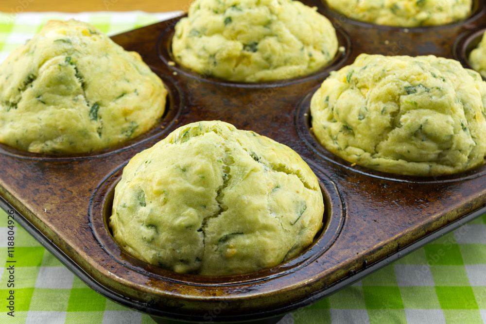 Spinach and feta cheese muffins close up in muffin tin pan Spinach and feta cheese muffins close up in muffin tin pan