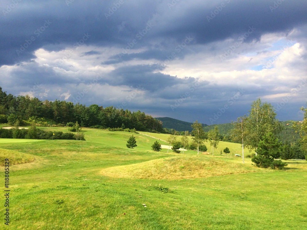 On a empty golf course before heavy storm