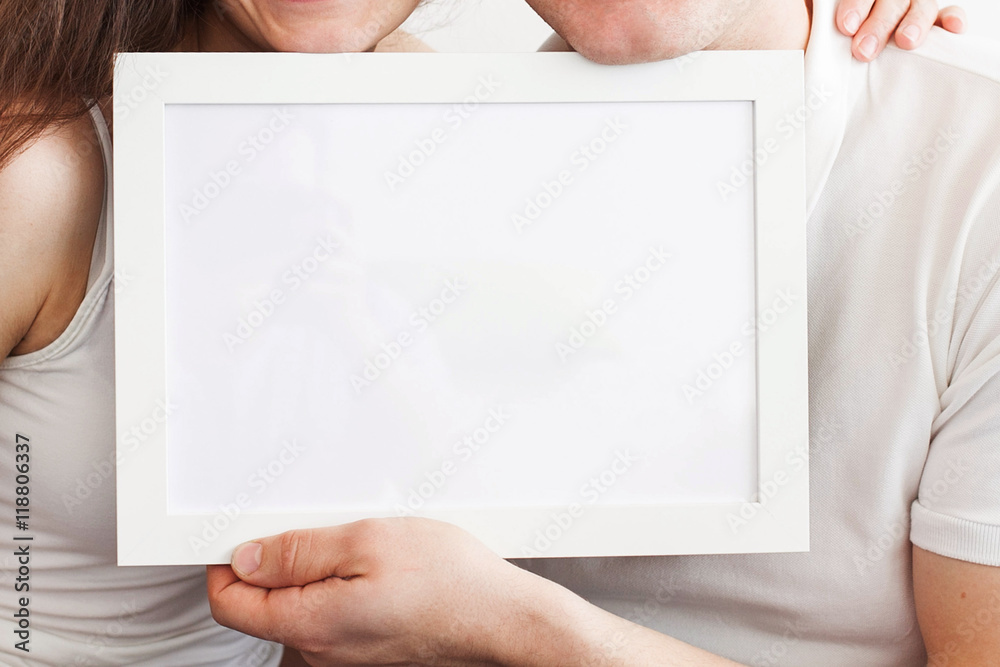 Hands of the man and the woman hold a frame with a clean sheet. Hands of the man and the woman hold a frame with a clean sheet.