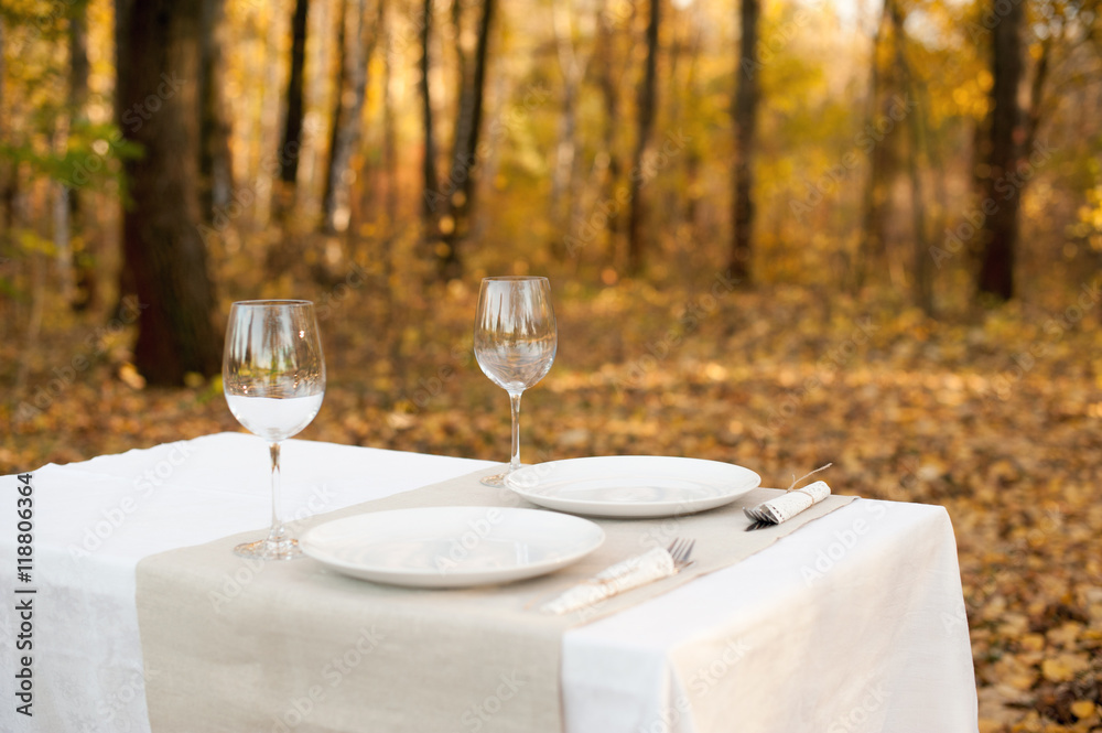 Fototapeta premium Decorated table in the autumn forest