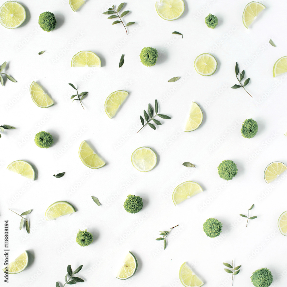 lime and green branches pattern on white background. flat lay, top view lime and green branches pattern on white background. flat lay, top view