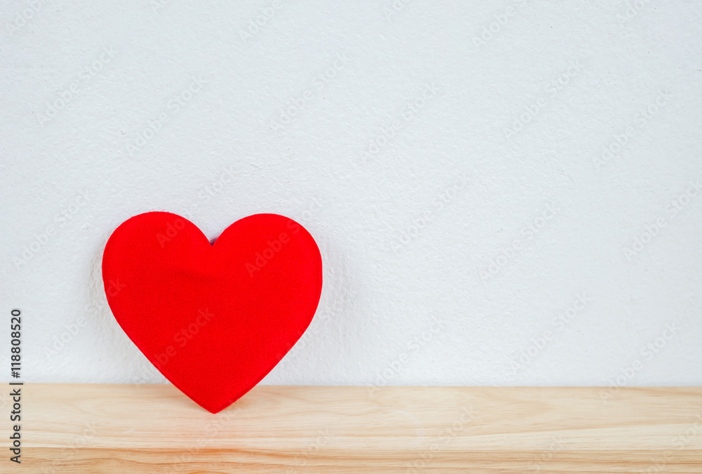 Red heart on wooden table and white wall with vintage tone Red heart on wooden table and white wall with vintage tone