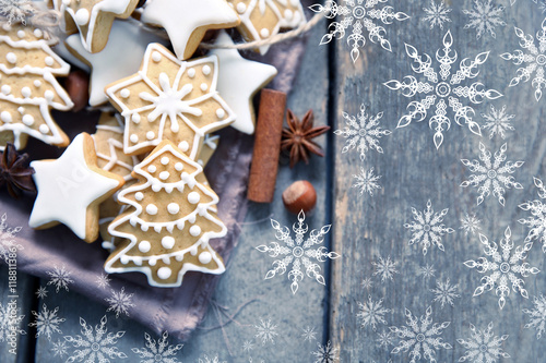 Christmas cookies with spices on wooden table. Snow effect