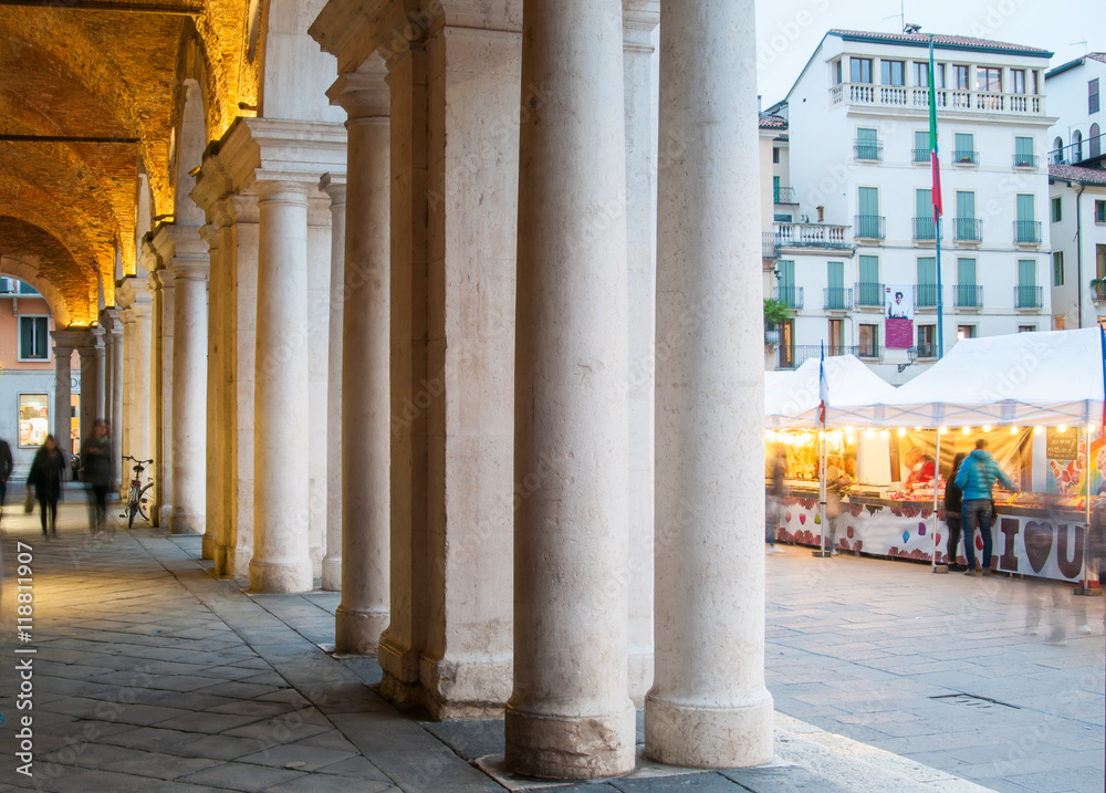 View of the columns and arches of the Palladian Basilica in Vicenza at dusk