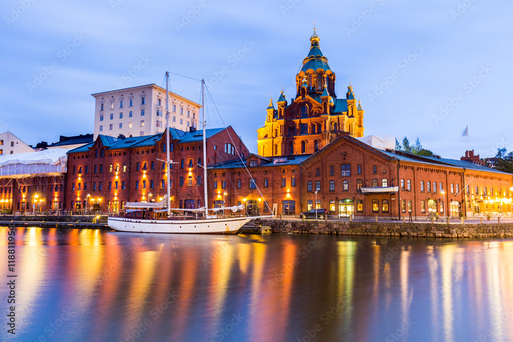 The Night view of the Orthodox Uspenski cathedral and lighted boat in the Harbour.
