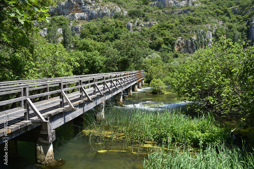 A wooden walkway across the 'Pearl Necklaces' cascade on the River Krka in Krka National Park, Sibenik-Knin County, Croatia.
 photo