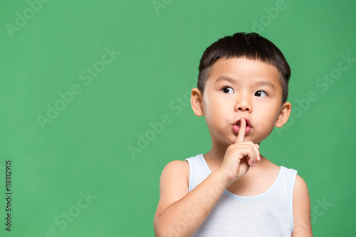 Little boy making a hush pose