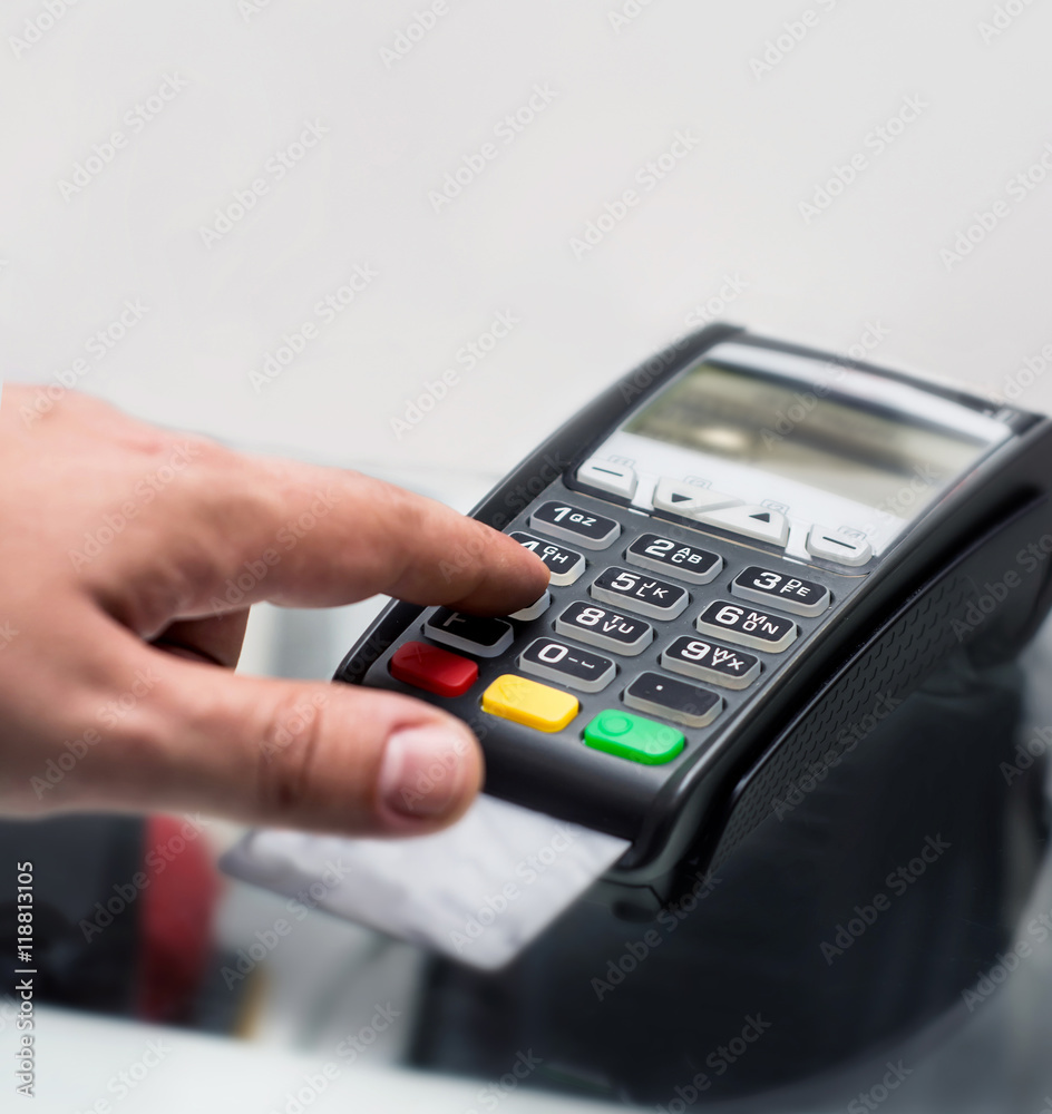 Credit or debit card password payment. Customer hand is entering pin Credit or debit card password payment. Customer hand is entering pin