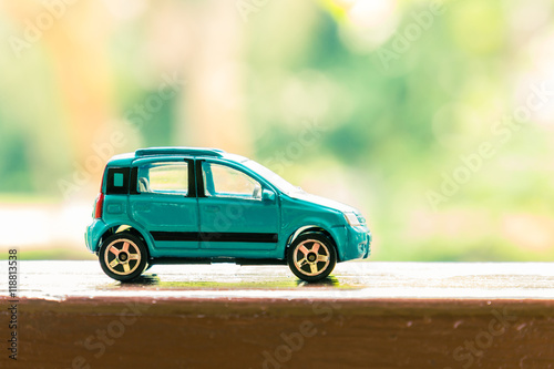 Hatchback car toy on wooden terrace
