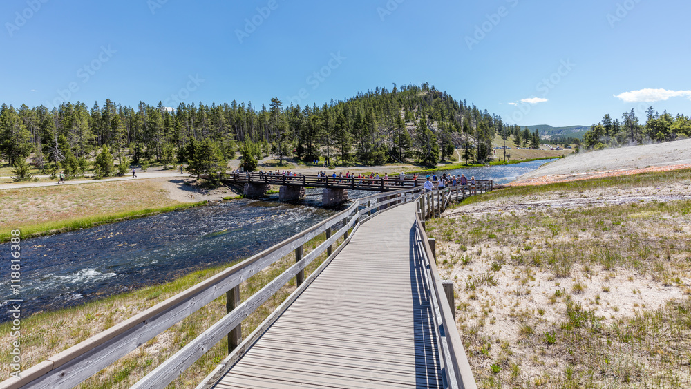 Wooden bridge across the Firehole River. Amazing scenery at Midway Geyser Basin, Yellowstone National Park, Wyoming