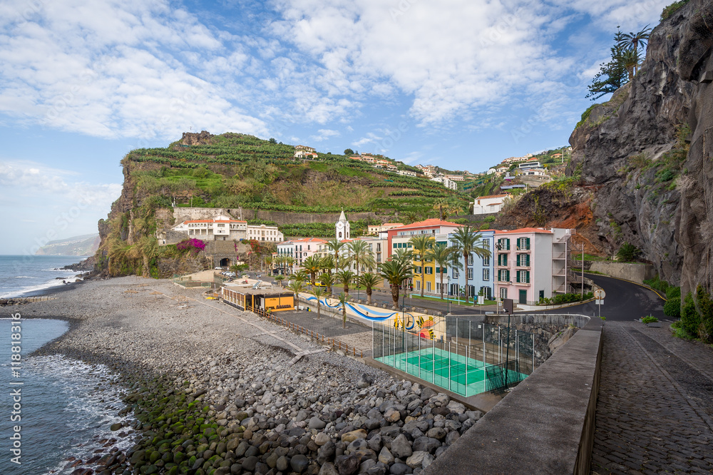 Ponta do Sol town with colorful houses surrounded by rucky mountains, Madeira.