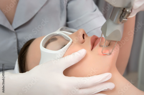 Wallpaper Mural Therapist beautician makes a  laser rejuvenation for the model  woman Torontodigital.ca