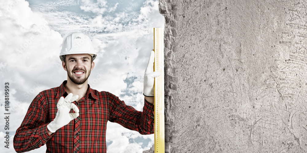 Builder checking spirit level . Mixed media Builder checking spirit level . Mixed media