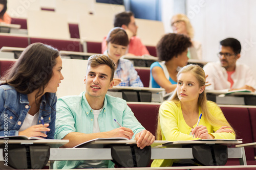 group of students with notebooks in lecture hall