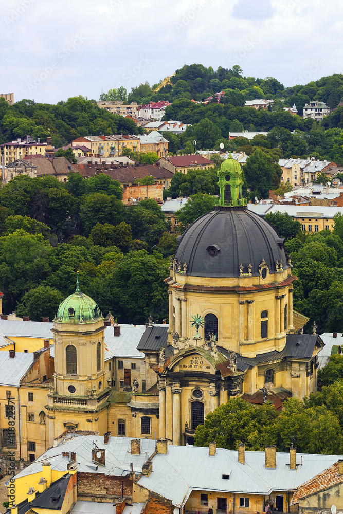 Top view house roof and Cathedral of old European city Lvov in Ukraine under cloudy blue sky