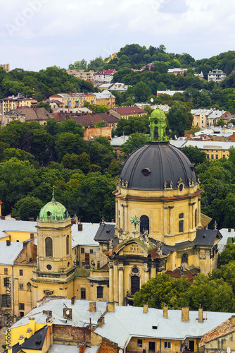 Top view house roof and Cathedral of old European city Lvov in Ukraine under cloudy blue sky