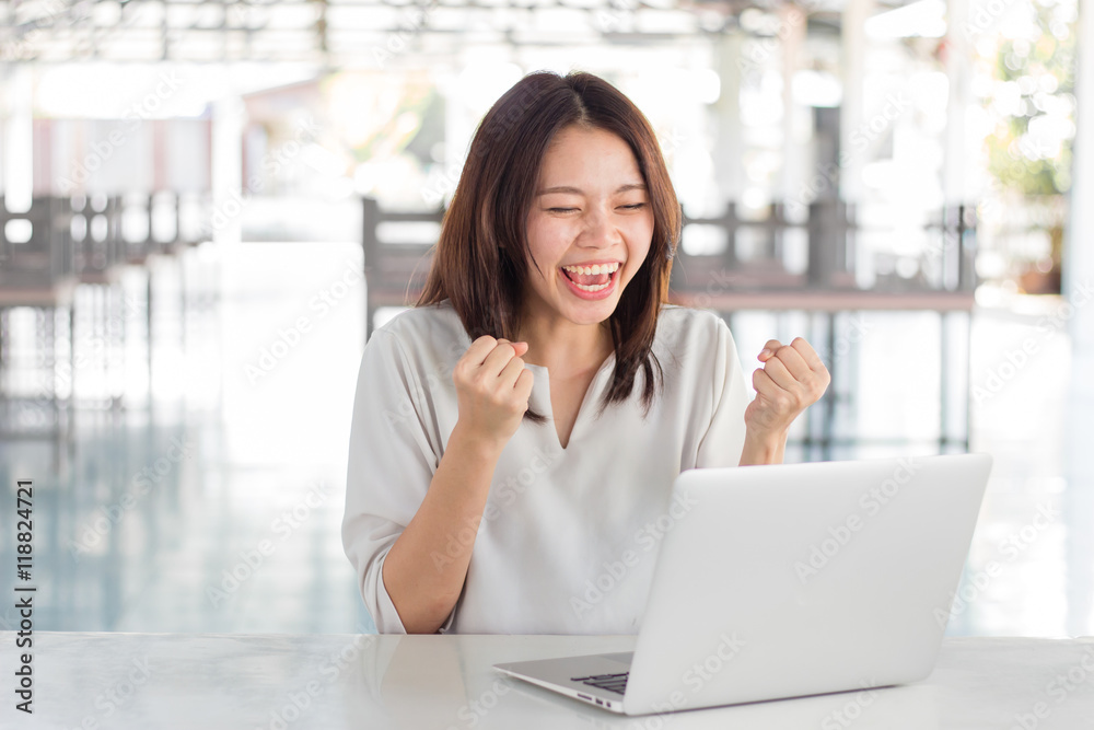 Woman using laptop computer with blurry background Woman using laptop computer with blurry background