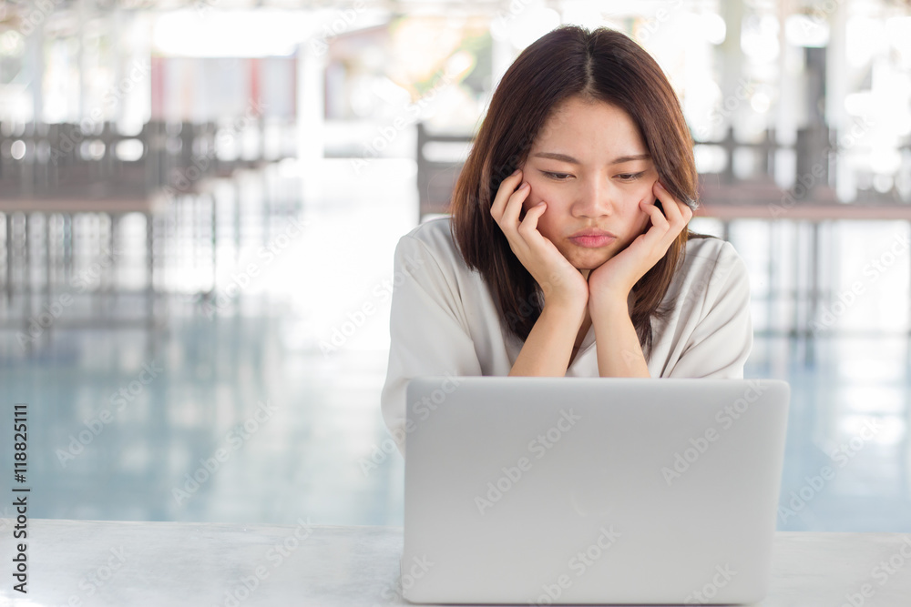 Woman using laptop computer with blurry background