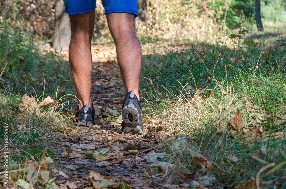 Young male cross country runner, legs and shoes detail. Young male cross country runner, legs and shoes detail.