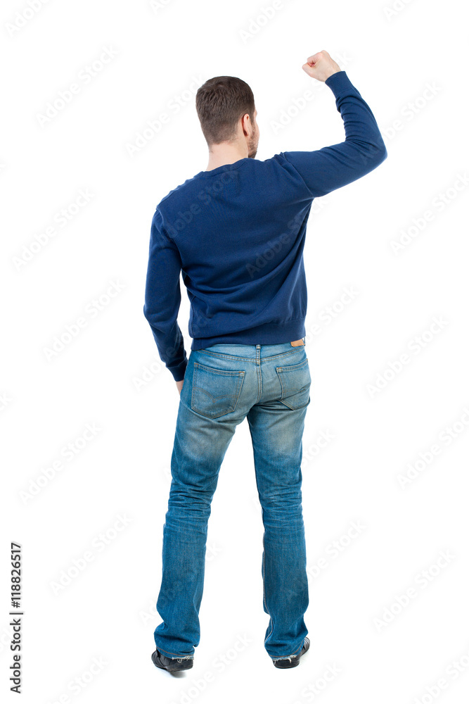 Back view of man. Raised his fist up in victory sign. Rear view people collection. backside view of person. Isolated over white background. bearded man in blue pullover showing biceps. Back view of man. Raised his fist up in victory sign. Rear view people collection. backside view of person. Isolated over white background. bearded man in blue pullover showing biceps.