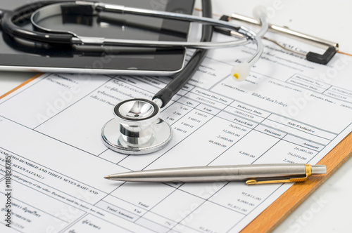 Stethoscope on medical billing statement on table, all text is a